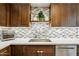 Kitchen showcasing stainless dishwasher and sink, counter space, and attractive backsplash at 5224 S Monaco Dr, Tempe, AZ 85283