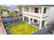 Modern home with a spacious backyard featuring newly installed sod and a sleek, covered patio area at 5533 E Earll Dr, Phoenix, AZ 85018