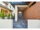 Inviting front porch with brick accents and a stylish blue front door at 5533 E Earll Dr, Phoenix, AZ 85018