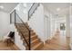 Stylish staircase with hardwood steps and black metal railings at 5533 E Earll Dr, Phoenix, AZ 85018