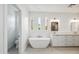 Elegant bathroom featuring a freestanding tub, dual vanities, and abundant natural light at 5537 E Earll Dr, Phoenix, AZ 85018