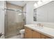 Modern bathroom featuring a glass-enclosed shower and sleek vanity with contemporary fixtures at 5537 E Earll Dr, Phoenix, AZ 85018