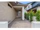 Covered entryway with modern brickwork, neutral colors, and desert landscaping at 5537 E Earll Dr, Phoenix, AZ 85018