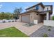 Modern two-story home featuring a brick facade, a two-car garage, and beautifully landscaped front yard at 5537 E Earll Dr, Phoenix, AZ 85018