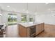 Bright kitchen featuring a large island, stainless steel appliances, and views of the backyard at 5537 E Earll Dr, Phoenix, AZ 85018