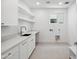 Well-lit laundry room features ample counter space, built-in shelves, and modern fixtures at 5537 E Earll Dr, Phoenix, AZ 85018