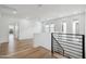 Bright loft space featuring hardwood floors, modern railing, and plenty of natural light from multiple windows at 5537 E Earll Dr, Phoenix, AZ 85018
