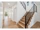 Bright entryway featuring modern wooden staircase with sleek black metal railing at 5537 E Earll Dr, Phoenix, AZ 85018