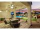 Inviting backyard patio with fire pit, leading to a pool and an outdoor kitchen and bar at 5628 N Rattler Way, Litchfield Park, AZ 85340