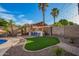 Backyard features artificial turf, a stone walkway and an outdoor kitchen and bar at 5628 N Rattler Way, Litchfield Park, AZ 85340