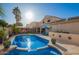 Beautiful backyard with a sparkling pool, manicured landscaping, and patio area at 5628 N Rattler Way, Litchfield Park, AZ 85340