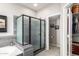 Well-appointed bathroom with a tiled shower, soaking tub, and convenient access to the closet at 5628 N Rattler Way, Litchfield Park, AZ 85340