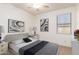 Staged bedroom with comfortable bed, modern decor, and natural light from window at 5628 N Rattler Way, Litchfield Park, AZ 85340