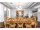 Dining room has a tray ceiling, wood table and chairs, and a large wooden china cabinet at 5628 N Rattler Way, Litchfield Park, AZ 85340