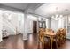 An open-concept living and dining room with wooden floors and stairs leading to the second floor at 5628 N Rattler Way, Litchfield Park, AZ 85340