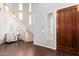 Elegant foyer with a curved staircase, hardwood floors, and designer accents at 5628 N Rattler Way, Litchfield Park, AZ 85340