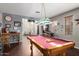 Spacious game room with a pool table, pinball machine, and curated decor for entertainment at 5628 N Rattler Way, Litchfield Park, AZ 85340