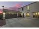 Large three-car garage with ample parking space and an extended driveway at 5628 N Rattler Way, Litchfield Park, AZ 85340