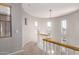 Second floor hallway features a curved landing, carpet, lots of windows, and natural light at 5628 N Rattler Way, Litchfield Park, AZ 85340