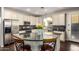 Stylish kitchen featuring stainless steel appliances, granite countertops, and ample cabinet space at 5628 N Rattler Way, Litchfield Park, AZ 85340