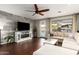 Comfortable living room featuring stylish furnishings, hardwood floors, and a cozy fireplace at 5628 N Rattler Way, Litchfield Park, AZ 85340