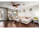 Bright and airy living room with an oversized sectional, hardwood floors, and backyard views at 5628 N Rattler Way, Litchfield Park, AZ 85340
