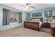 Spacious main bedroom with wood-framed bed, ceiling fan, and multiple windows for natural light at 5628 N Rattler Way, Litchfield Park, AZ 85340