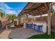 Outdoor kitchen with a bar and grill area perfect for entertaining at 5628 N Rattler Way, Litchfield Park, AZ 85340