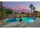 Inviting backyard pool and spa with lush landscaping and outdoor seating at 5628 N Rattler Way, Litchfield Park, AZ 85340