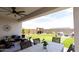 Inviting back patio featuring ample seating, lush greenery, and an outdoor dining area at 5633 N 206Th Ave, Buckeye, AZ 85396