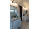 This bathroom offers dual vanities, stone countertops, and tiled floors at 5633 N 206Th Ave, Buckeye, AZ 85396