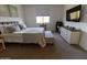Inviting bedroom featuring a comfortable bed, a window, and a dresser with sleek decor at 5633 N 206Th Ave, Buckeye, AZ 85396