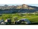 Scenic golf course view with desert rocks and mountain backdrop, showcasing the natural beauty of the community at 5633 N 206Th Ave, Buckeye, AZ 85396