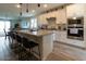 Open concept kitchen features a large island, seating, and stainless steel appliances at 5633 N 206Th Ave, Buckeye, AZ 85396