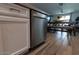 Modern dishwasher set in white cabinets with stone countertops and wood-look flooring at 5633 N 206Th Ave, Buckeye, AZ 85396