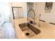 Modern kitchen featuring a stainless steel sink, elegant faucet, and granite countertop at 5633 N 206Th Ave, Buckeye, AZ 85396