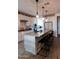 Open kitchen with a large island, white cabinets, modern appliances, and pendant lighting at 5633 N 206Th Ave, Buckeye, AZ 85396