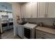 Well organized laundry room with cabinets and countertops at 5633 N 206Th Ave, Buckeye, AZ 85396