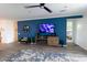 Stylish living room with a blue accent wall, TV, modern furniture, and a view to the bedroom at 5633 N 206Th Ave, Buckeye, AZ 85396
