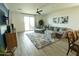 Bright living room featuring a sliding glass door, plush seating, and neutral color palette at 5633 N 206Th Ave, Buckeye, AZ 85396