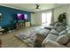 Inviting living room with a comfortable couch, patterned rug, and access to the backyard at 5633 N 206Th Ave, Buckeye, AZ 85396