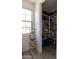 Walk-in pantry with ample shelving, a rolling rack, and organized food storage at 5633 N 206Th Ave, Buckeye, AZ 85396