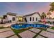 Expansive backyard with a pool, outdoor seating, artificial turf, and a covered patio at 6518 W Louise Dr, Glendale, AZ 85310