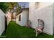 Charming backyard with artificial turf, seating, and lovely exterior stucco at 6518 W Louise Dr, Glendale, AZ 85310