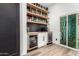 Bar area features wine and beverage fridges, floating shelves, and a sink with a beverage center at 6518 W Louise Dr, Glendale, AZ 85310