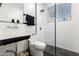 Modern bathroom featuring stylish fixtures, a walk-in shower, and a sleek black-and-white design at 6518 W Louise Dr, Glendale, AZ 85310