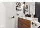Modern bathroom featuring a decorative mirror, stylish sconces, and a vanity with ample storage at 6518 W Louise Dr, Glendale, AZ 85310