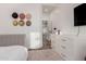Bright bedroom features stylish decor, a modern dresser, and ample closet space with wood-style flooring at 6518 W Louise Dr, Glendale, AZ 85310