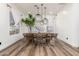 Bright dining room featuring modern lighting and a rustic wooden table at 6518 W Louise Dr, Glendale, AZ 85310