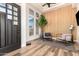 Bright foyer featuring wood-look floors, accent wall, modern decor, and natural light at 6518 W Louise Dr, Glendale, AZ 85310
